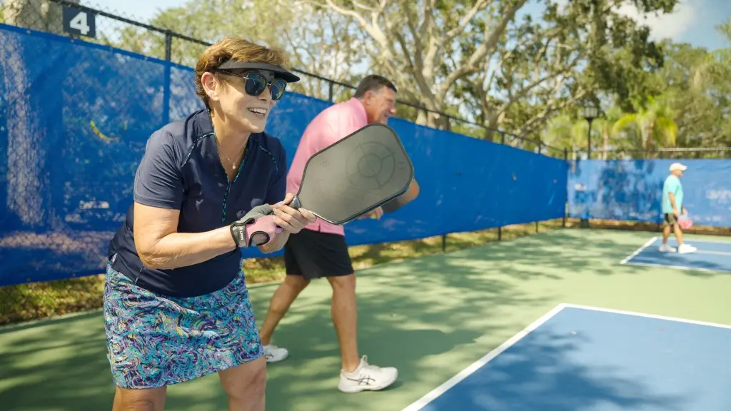 Happy Grand Harbor member playing pickleball